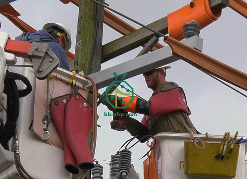 Installation of fiberglass crossarms for power transmission line